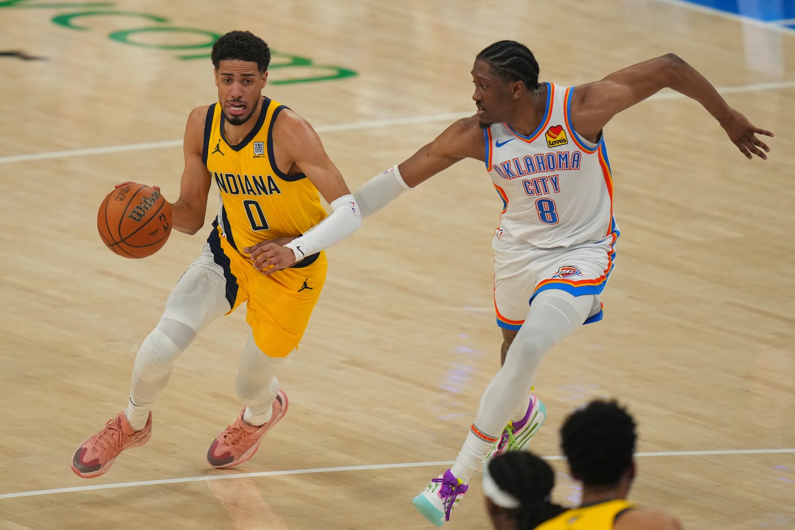 Indiana Pacers guard Tyrese Haliburton (0) drives as Oklahoma City Thunder forward Jalen Williams (8) defends during the first half of Game 5 of the NBA Finals basketball series, Monday, June 16, 2025, in Oklahoma City. (AP Photo/Nate Billings)
