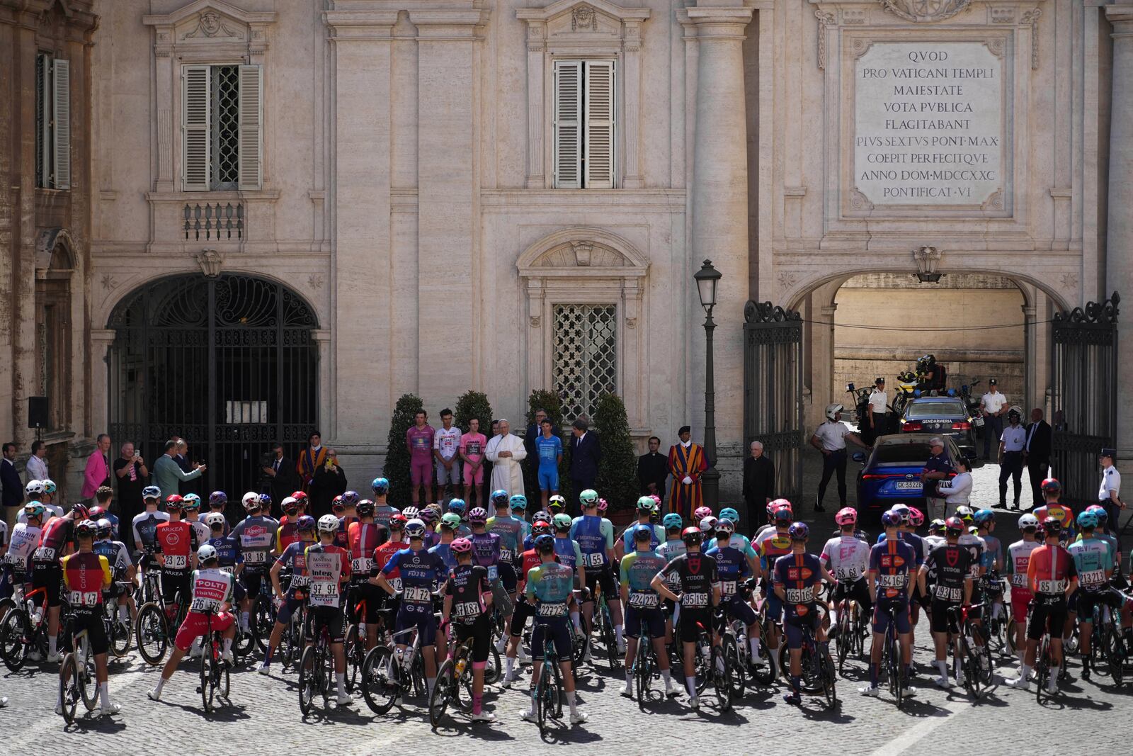 Flanked by race leaders, from left, Denmark's Mads Pedersen, Mexico's Isaac Del Toro, Britain's Simon Yates and Italy's Lorenzo Fortunato, Pope Leo XIV blesses the pack before the start of the final stage of the Giro d'Italia, at the Vatican, Sunday, June 1, 2025. (AP Photo/Andrew Medichini)
