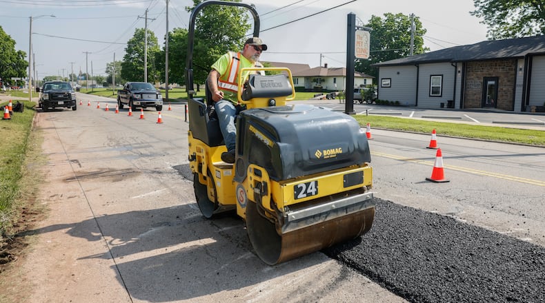 Crews perform road work on North Main Street on Thursday, May 15, 2025, in Urbana. JOSEPH COOKE/STAFF