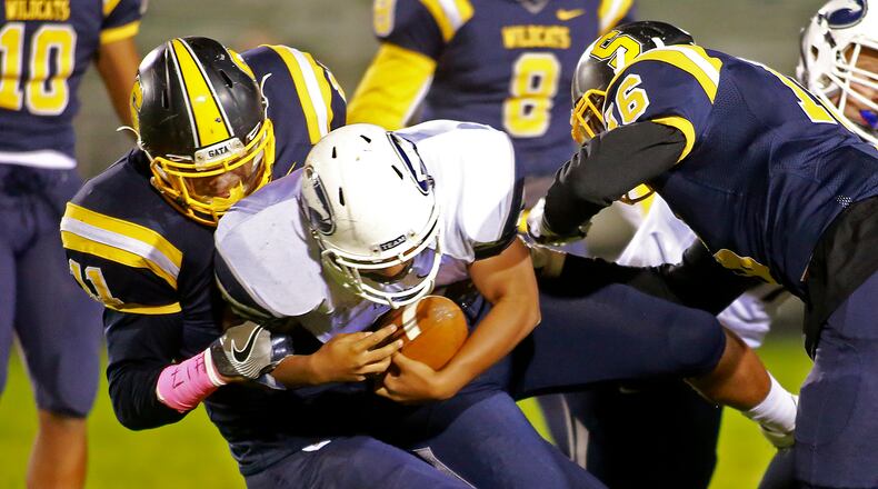 Springfield’s Leonard Taylor tackles Fairmont’s Darnell Boulware as he tries to run up the middle during a game last season. Bill Lackey/Staff