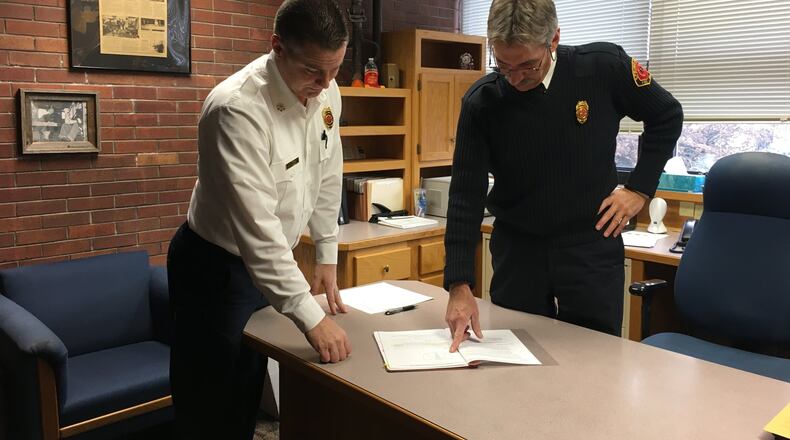 Soon to be Springfield Fire Chief Brian Miller and soon to retired Springfield Fire Chief Nick Heimlich look over plans for the division.