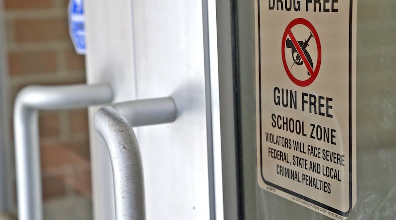 A sign telling everyone entering Fulton Elementary that it's a gun and drug free zone is displayed on the front door Wednesday, August 3, 2022. BILL LACKEY/STAFF