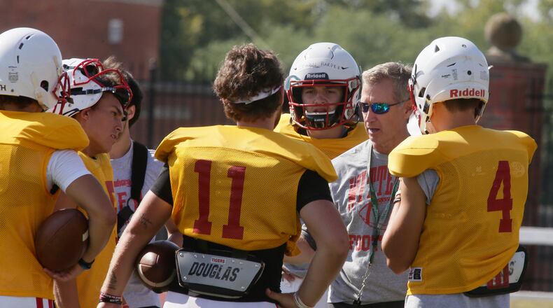 Wittenberg coach Jim Collins talks to the quarterbacks during practice on Thursday, Aug. 18, 2022, at Edwards-Maurer Field in Springfield. David Jablonski/Staff