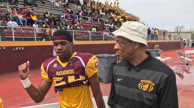 Former NFL player and veteran college coach George Ragsdale (left), who is now Central State s wide receivers coach, on sideline with Marauders Devon Cunningham during Saturday s annual Spring Showcase at McPherson Stadium. Tom Archdeacon/STAFF