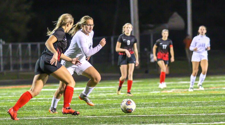 Cutline 1: Catholic Central sophomore Becca Samosky and Milton-Union senior Annie Bennet race for the ball during their Division III, Dayton 3 district semifinal match at Beavercreek’s Miami Valley Hospital Stadium on Tuesday night. The Bulldogs won 1-0. MICHAEL COOPER/CONTRIBUTED PHOTO
