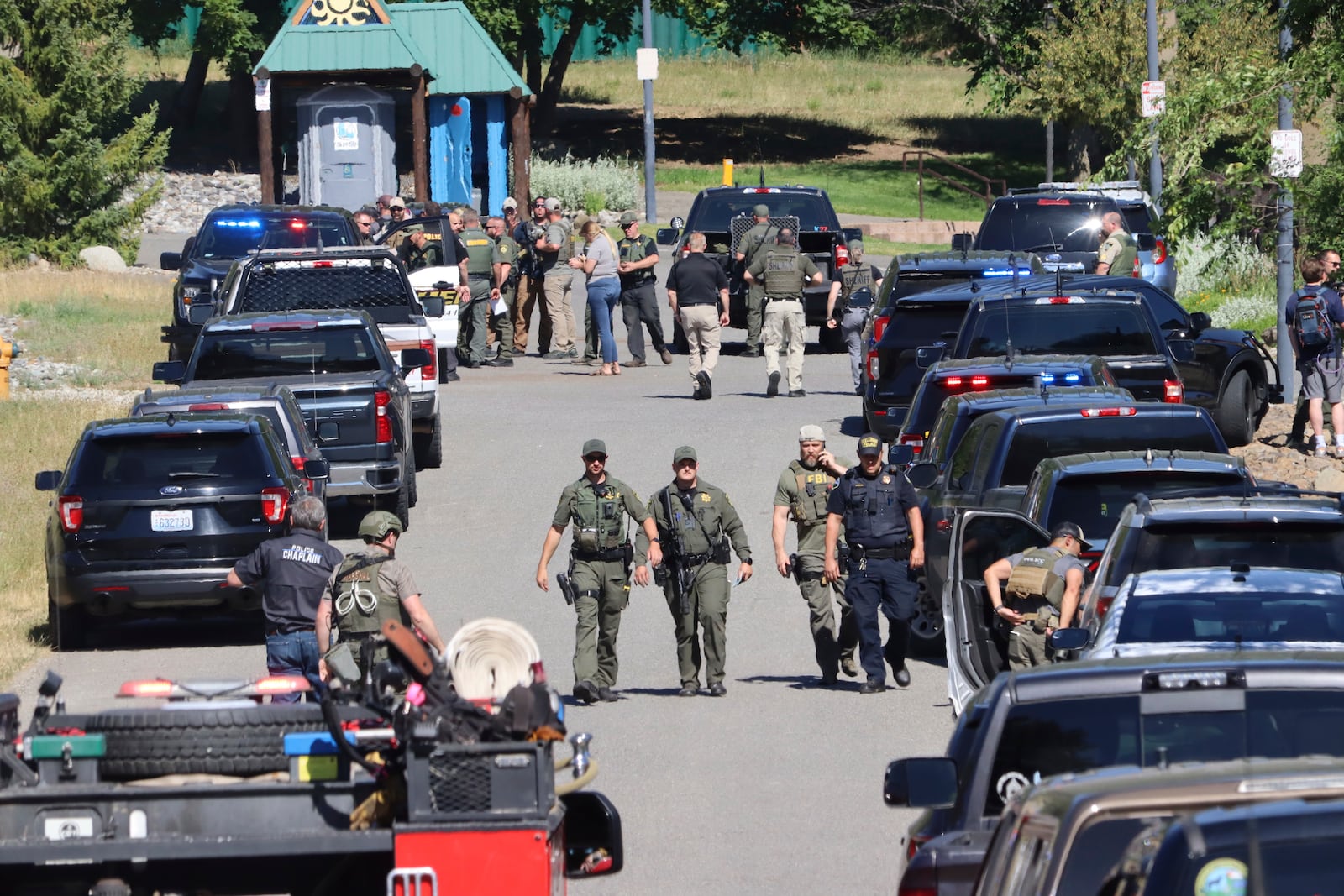 Law enforcement and emergency responders at Cherry Hill Park off 15th Street on Sunday afternoon, June 29, 2025, following reports of an ambush shooting attack on Canfield Mountain, in Coeur d'Alene, Idaho. (Bill Buley/Coeur D'Alene Press via AP)
