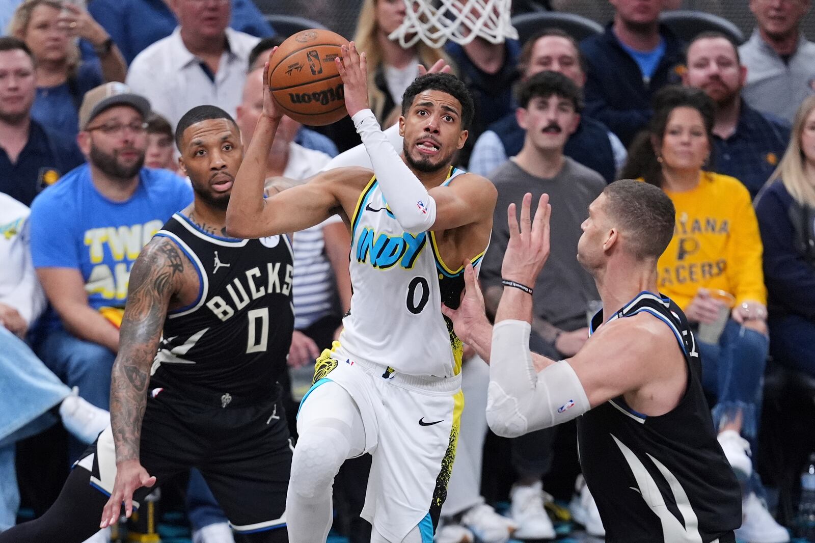Indiana Pacers guard Tyrese Haliburton (0) shoots over Milwaukee Bucks center Brook Lopez (11) during the second half of a first-round NBA basketball playoff game in Indianapolis, Tuesday, April 22, 2025. (AP Photo/Michael Conroy)
