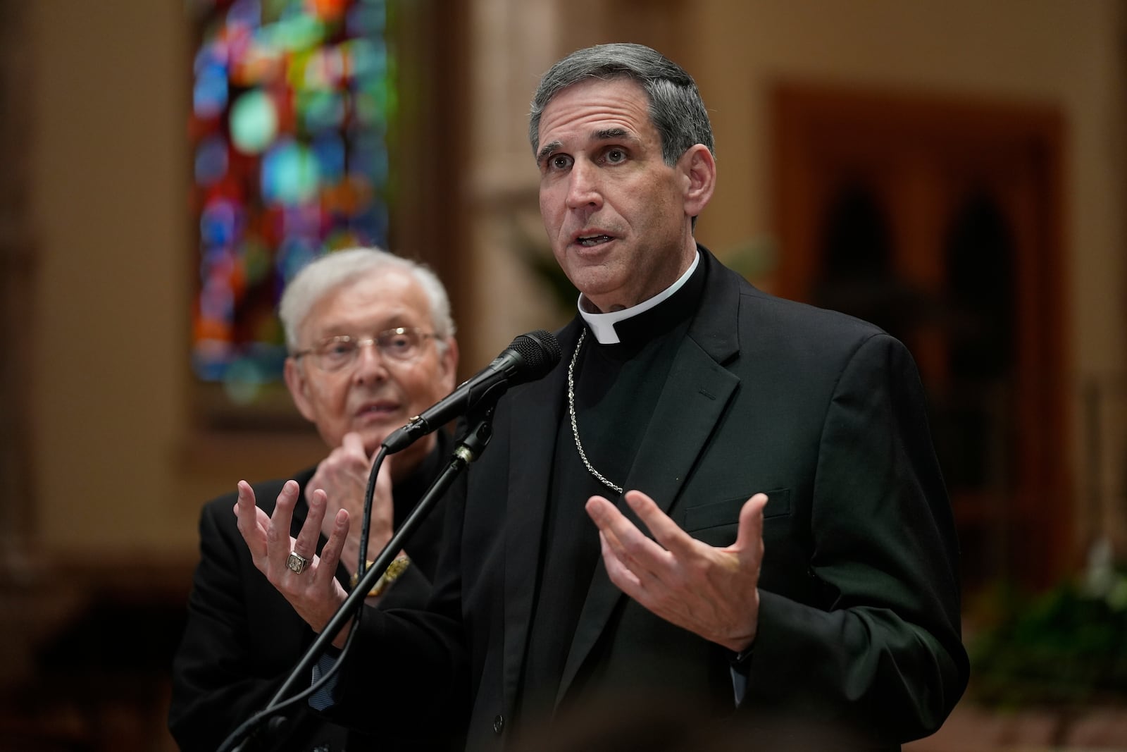 Bishop Lawrence J. Sullivan, Vicar General of the Archdiocese of Chicago, speaks as Father Gregory Sakowicz listens at Holy Name Cathedral, on Wednesday, May 8, 2025 in Chicago. (AP Photo/Erin Hooley)