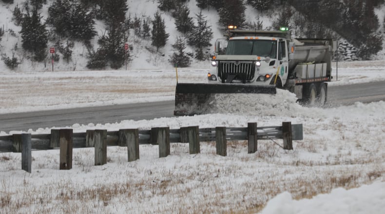 An ODOT plow truck cleans off the the left lane on Southbound Ohio Route 4 in Clark County Sunday. BILL LACKEY/STAFF