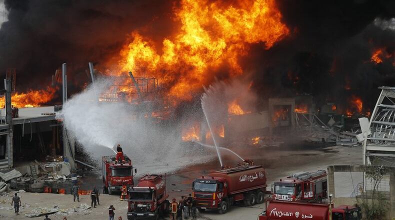 Fire burns in the port in Beirut, Lebanon, Thursday, Sept. 10. 2020. A huge fire broke out Thursday at the Port of Beirut, triggering panic among residents traumatized by last month's massive explosion that killed and injured thousands of people. (AP Photo/Hussein Malla)