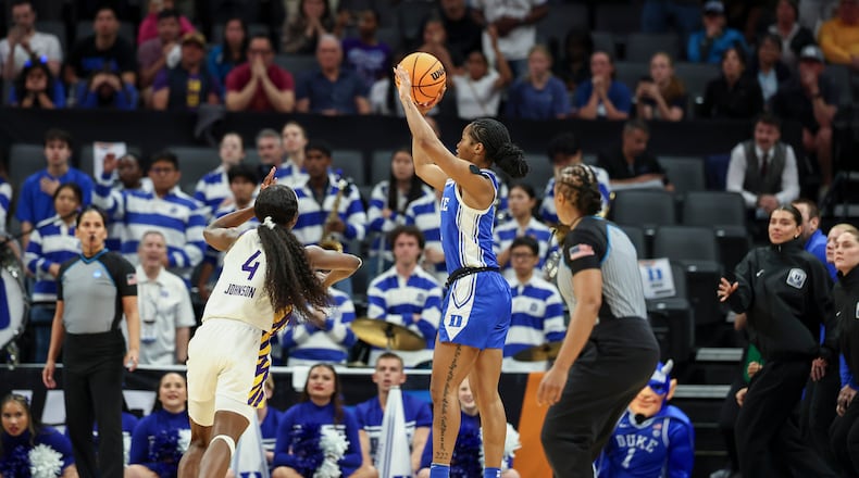 Duke guard Ashlon Jackson, center, makes a 3-pointer over LSU guard Flau'jae Johnson (4) as the clock runs out in the fourth quarter in the Sweet 16 of the NCAA college basketball tournament Friday, March 27, 2026, in Sacramento, Calif. (AP Photo/Sara Nevis)