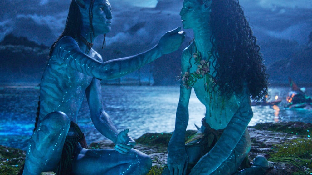 This image released by Disney shows Lo'ak, performed by Britain Dalton, left, and Tsireya, performed by Bailey Bass in a scene from "Avatar: Fire and Ash." (20th Century Studios/Disney via AP)