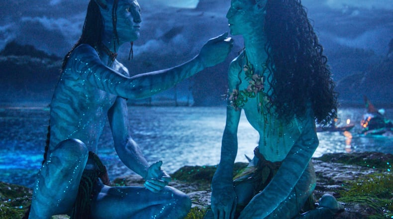 This image released by Disney shows Lo'ak, performed by Britain Dalton, left, and Tsireya, performed by Bailey Bass in a scene from "Avatar: Fire and Ash." (20th Century Studios/Disney via AP)