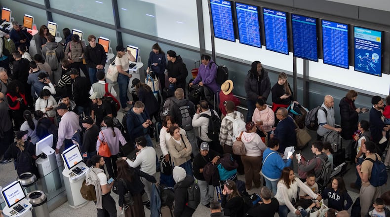 People wait in a TSA line at the John F. Kennedy International Airport, Sunday, March 22, 2026, in New York. (AP Photo/Yuki Iwamura)