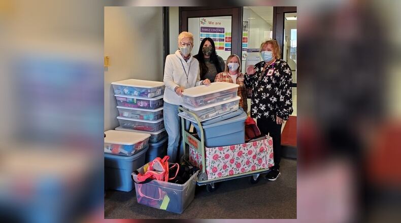 The Clark State College Early Childhood Education (ECE) program students will host the second annual Duffle Shuffle through Nov. 18. Here are the employees of Clark County Children Services with the 2021 donations. Contributed/Clark State College