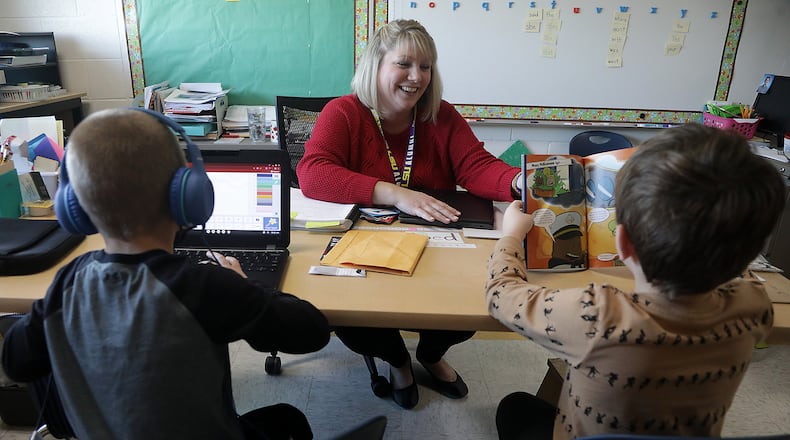 Ashley DuGan works with students in the Learning Recovery program at Northwestern Elementary School Thursday. BILL LACKEY/STAFF