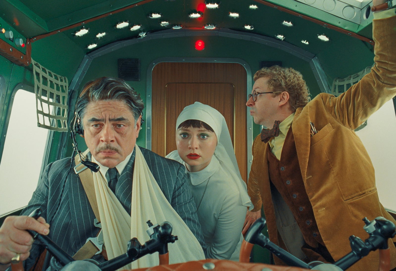 This image released by Focus Features shows Benicio del Toro, left, Mia Threapleton, center, and Michael Cera in a scene from "The Phoenician Scheme." (TPS Productions/Focus Features via AP)