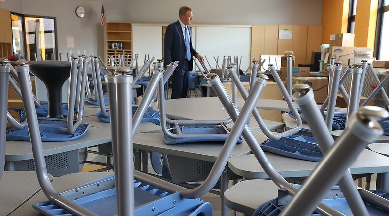 Greenon Superintendent Darrin Knapke looks over a classroom full of items that were brought to the new school from the old Enon Elementary Thursday. BILL LACKEY/STAFF