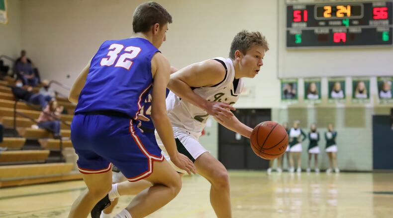Catholic Central High School junior Ian Galluch drives past Greeneview sophomore Ethen Caudill during their game on Tuesday night at Jason Collier Gymnasium in Springfield. Galluch's basket with 7.5 seconds remaining lifted the Irish to a 60-59 win. Michael Cooper/CONTRIBUTED