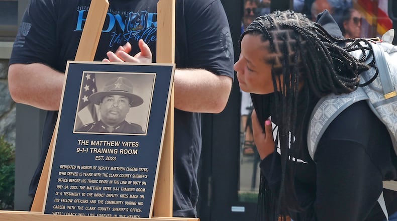 A'kaylehana Yates looks at the plaque dedicating the 9-1-1 Training Room after her father Friday, August 25, 2023 during a dedication ceremony for the new 9-1-1 Communication Center. BILL LACKEY/STAFF