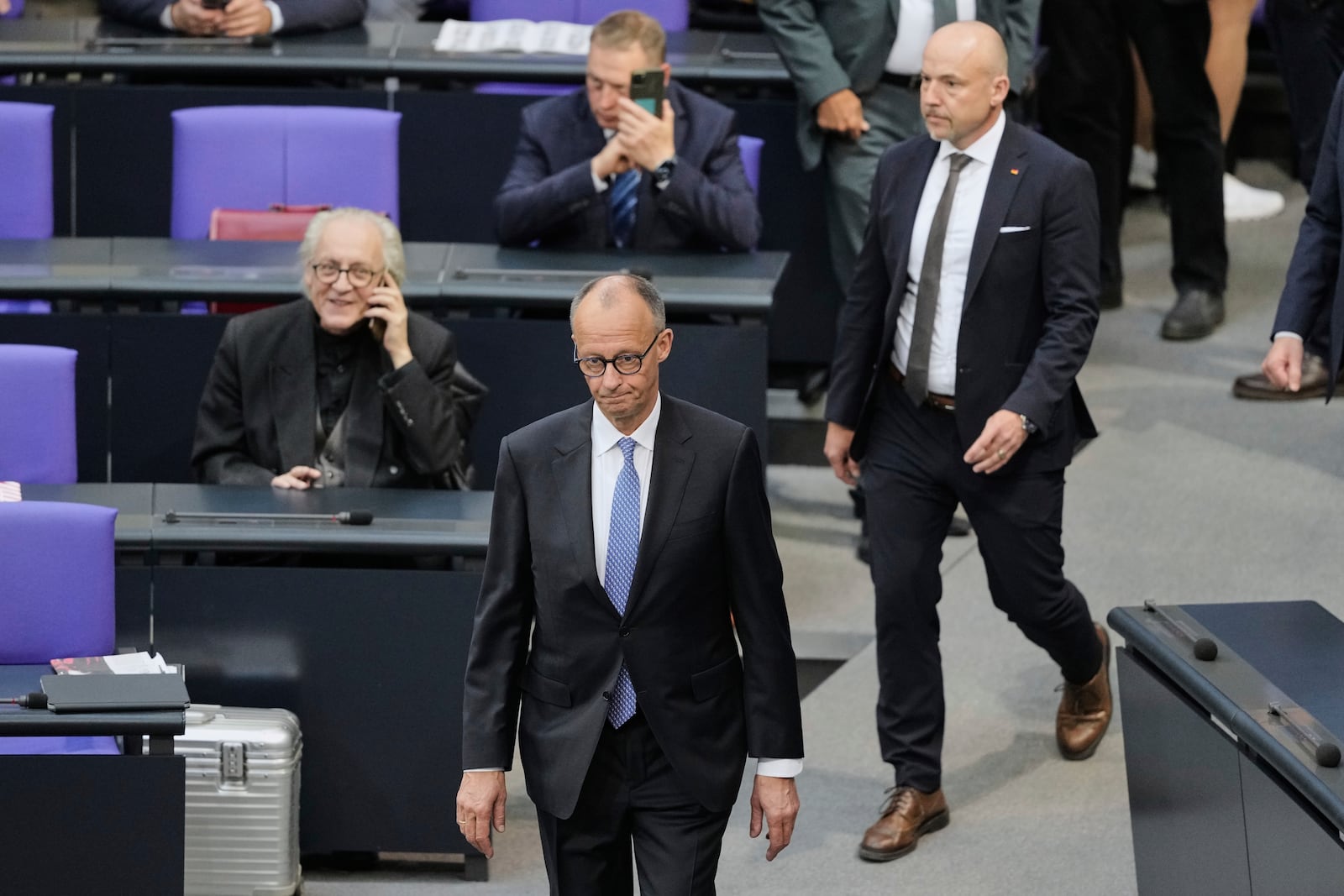 Friedrich Merz walks in the plenary after he was not elected new Chancellor in the first voting process at the parliament Bundestag in Berlin, Tuesday, May 6, 2025. (AP Photo/Markus Schreiber)