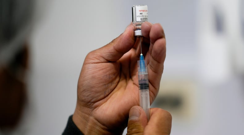 FILE - A healthcare worker prepares a shot of the Pfizer COVID-19 vaccine in La Paz, Bolivia, Jan. 7, 2025. (AP Photo/Juan Karita, File)