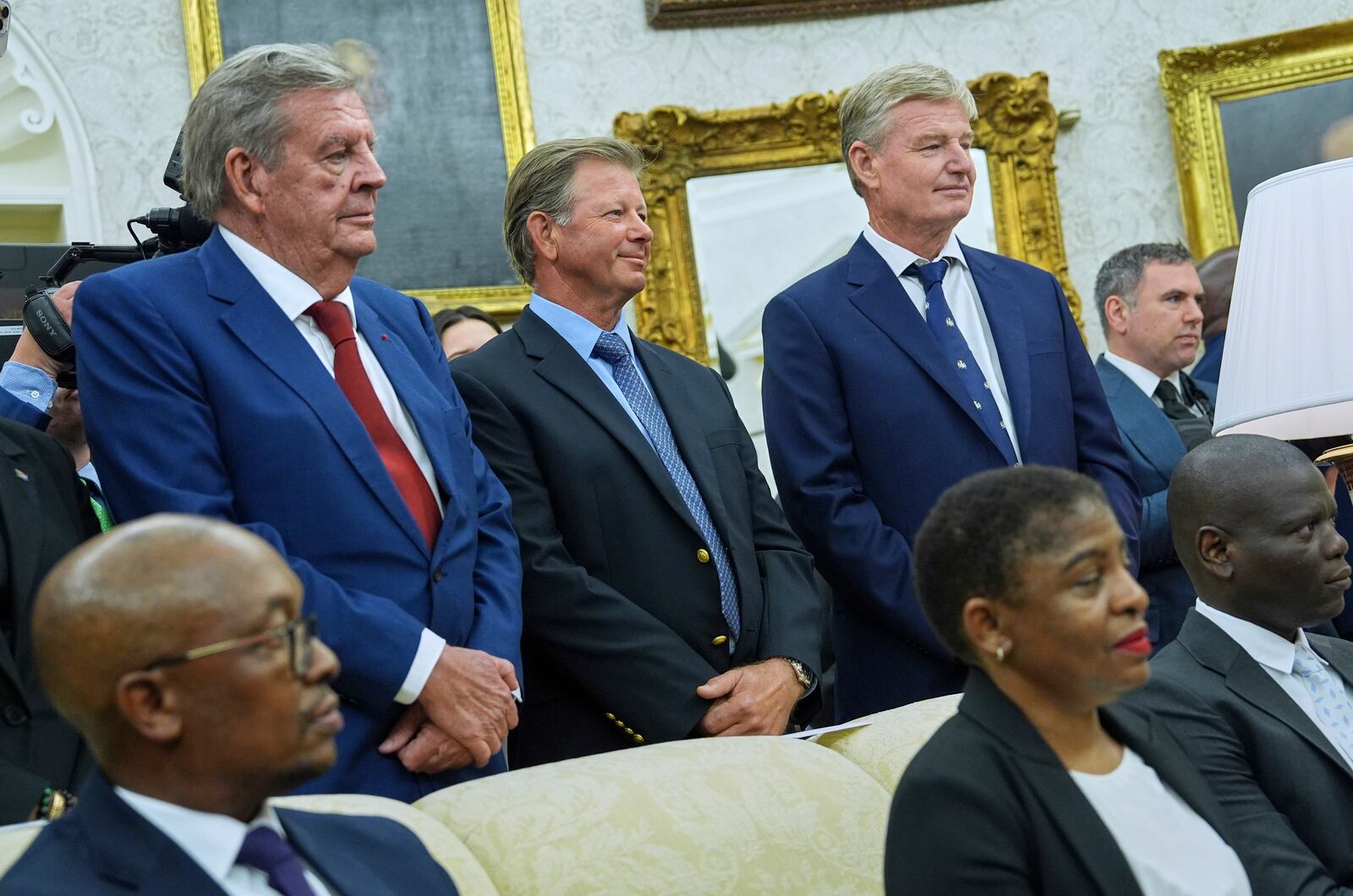 Johann Rupert, left, looks on as President Donald Trump meets South African President Cyril Ramaphosa in the Oval Office of the White House, Wednesday, May 21, 2025, in Washington. (AP Photo/Evan Vucci)