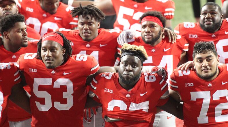 Ohio State players, including Robert Landers, center, sing “Carmen Ohio” after a victory against Indiana on Saturday, Oct. 6, 2018, at Ohio Stadium in Columbus. David Jablonski/Staff