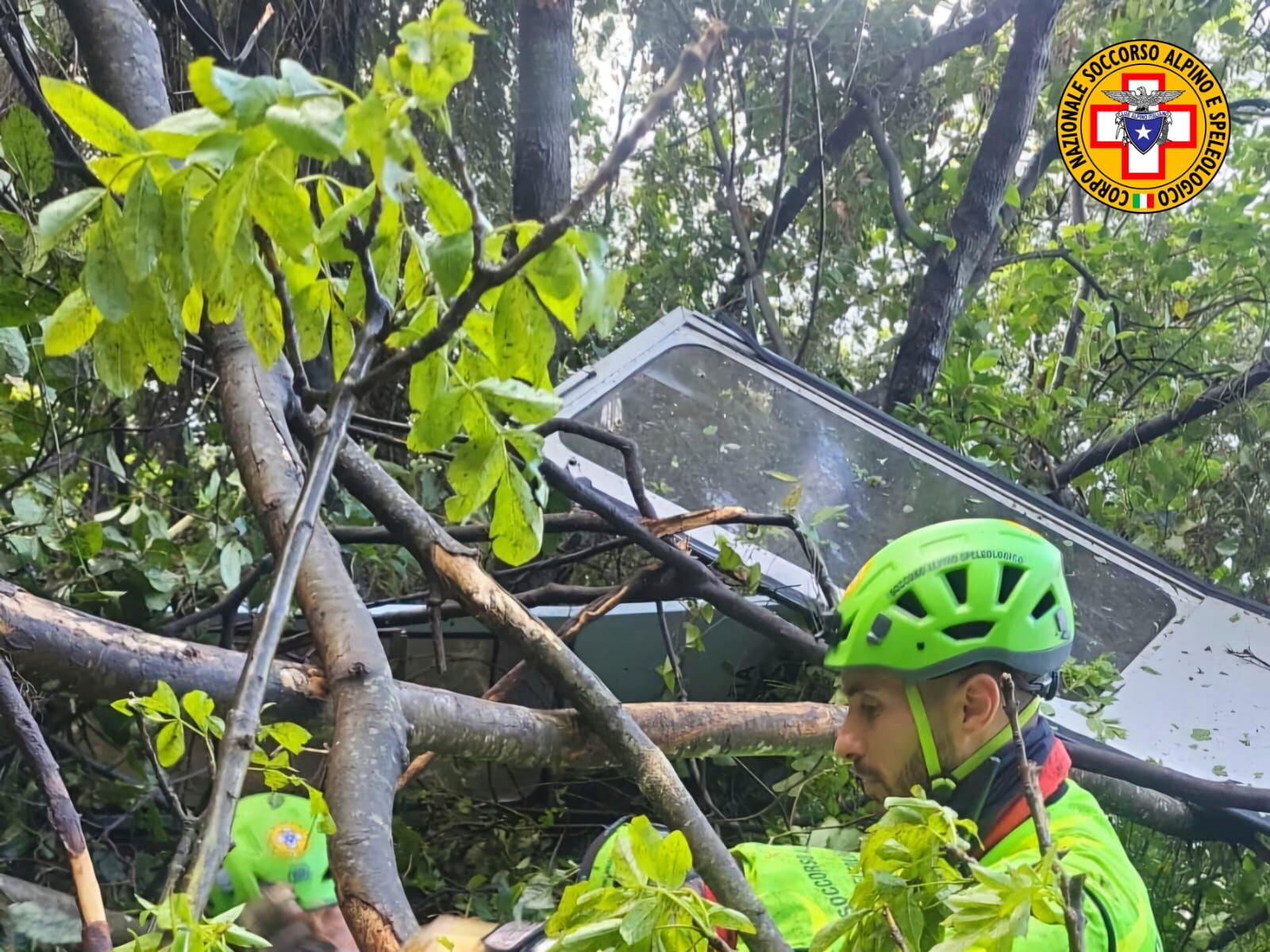 In this photo released by the Italian Alpine and Speleological Rescue Corps on Thursday, April 17, 2025, rescuers reach for the smashed gondola of the Mt. Faito cable car near Naples in southern Italy.