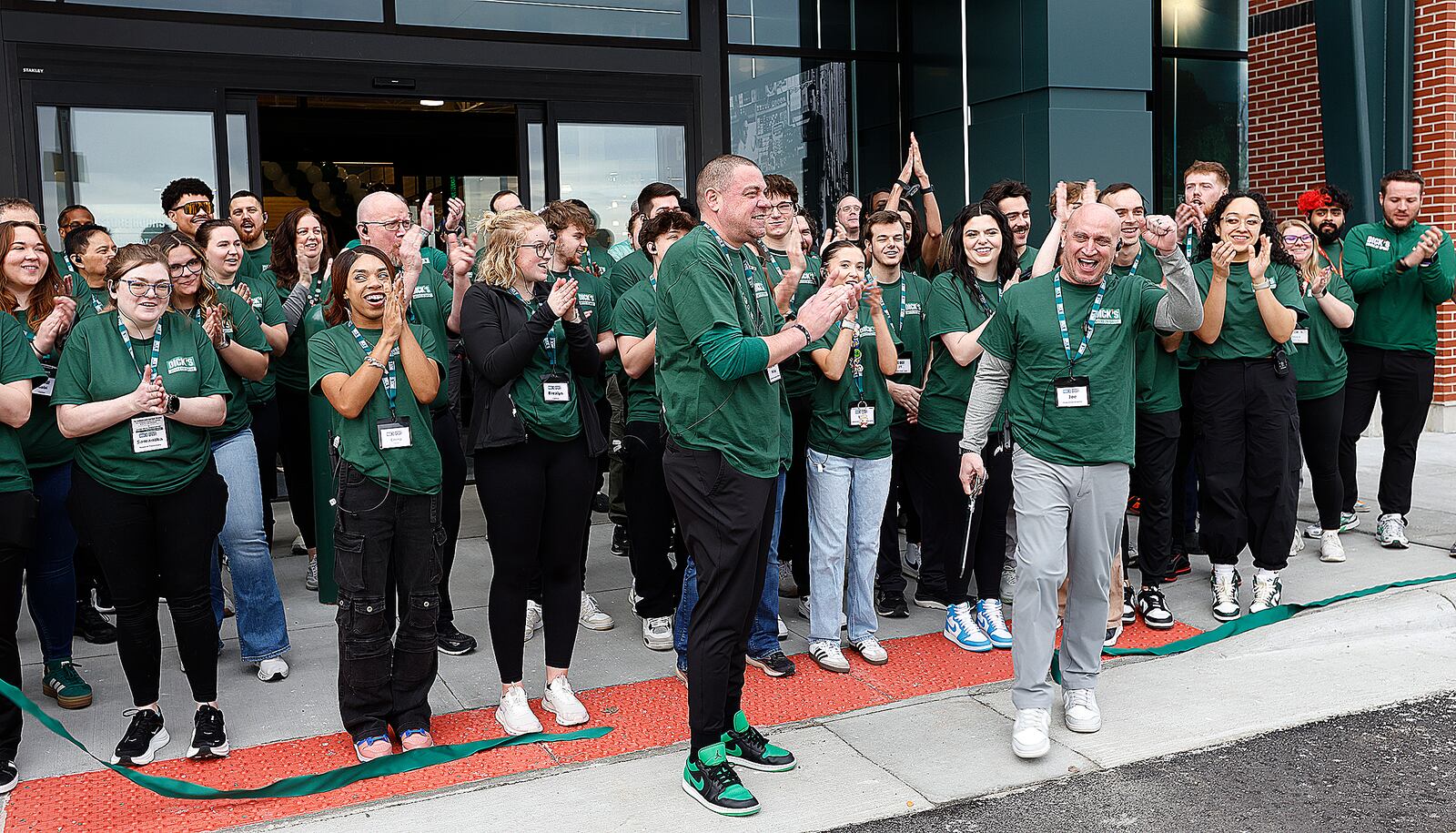 The staff at the new Dick's House of Sport at Fairfield Commons cheer Friday, March 7, 2025 after the ribbon cutting ceremony. MARSHALL GORBY\STAFF