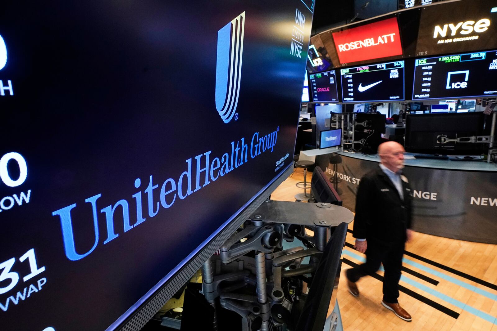 The logo for UnitedHealth Group appears above a trading post on the floor of the New York Stock Exchange, Thursday, April 17, 2025. (AP Photo/Richard Drew)