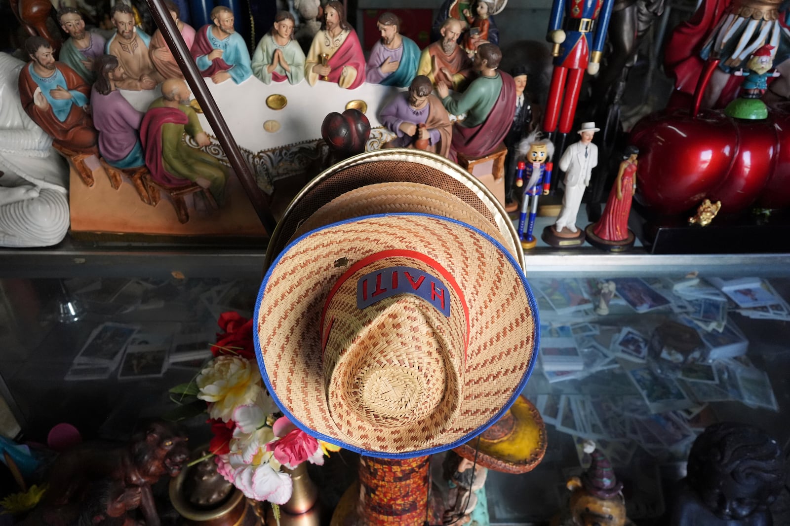 Haiti-decorated hats are displayed for sale among other items, inside 3x3 Santa Barbara Botanica in Miami's Little Haiti neighborhood, Friday, June 6, 2025. (AP Photo/Rebecca Blackwell)