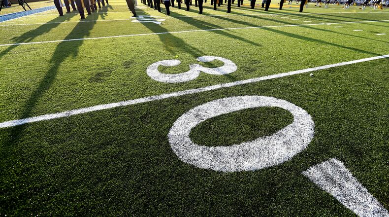 The Springfield High School Marching Band play the National Anthem on the new artificial turf that has been installed at Evans Stadium Friday before the start of the Wildcats’ football game against Lima Senior. Bill Lackey/Staff