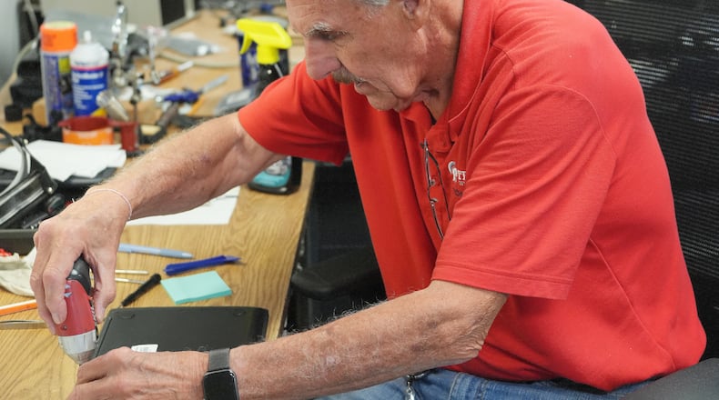 Tom Schelkun, a member of the Troy City Schools technology department, services one of the district's nearly 5,000 Chromebook computers. Schelkun has spent the past 20 years working in the district's technology department. Prior to that, he spent 35 years teaching physical education in Troy. CONTRIBUTED PHOTO / TROY CITY SCHOOLS