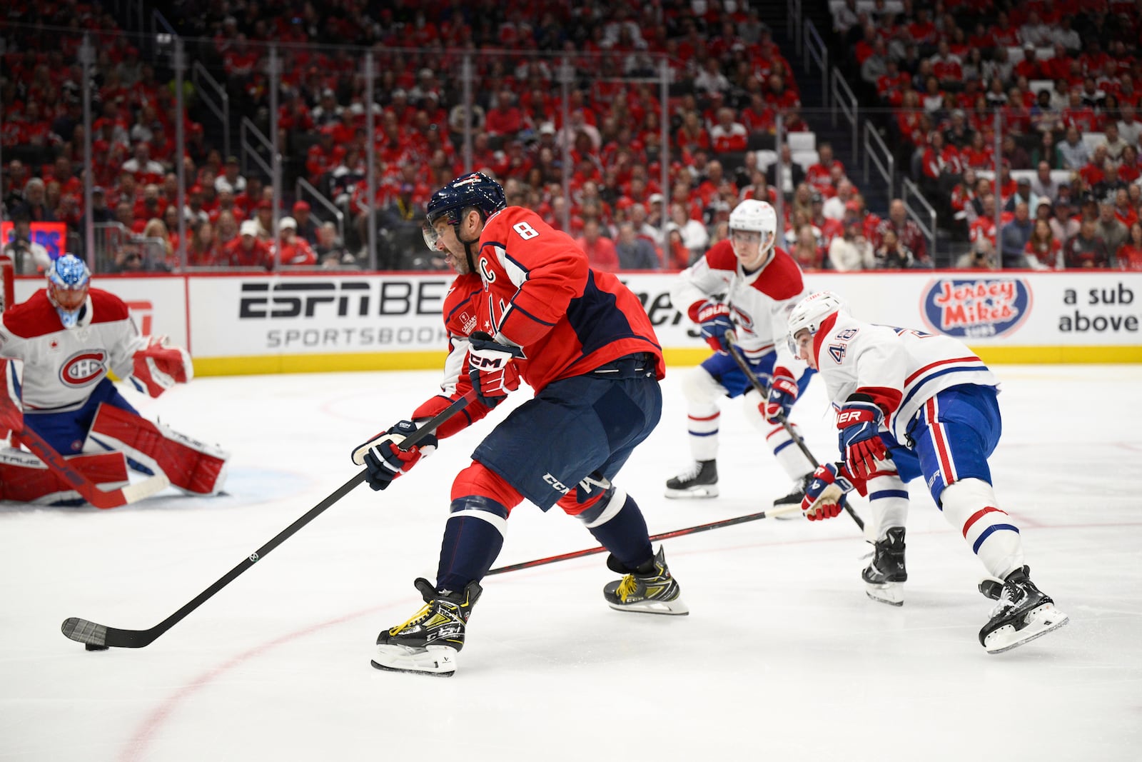 Washington Capitals left wing Alex Ovechkin (8) skates with the puck past Montreal Canadiens defenseman Lane Hutson (48) in the first period of Game 5 of a first-round NHL hockey playoff series Wednesday, April 30, 2025, in Washington. (AP Photo/Nick Wass)