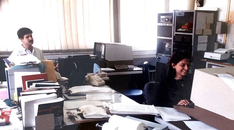 This handout photo provided by Hasan Mroue, shows Mona Ziade, right, and newsman Hasan Mroue work at the AP Middle East head office in Nicosia, Cyprus in the late 1980s. (Hasan Mroue via AP)