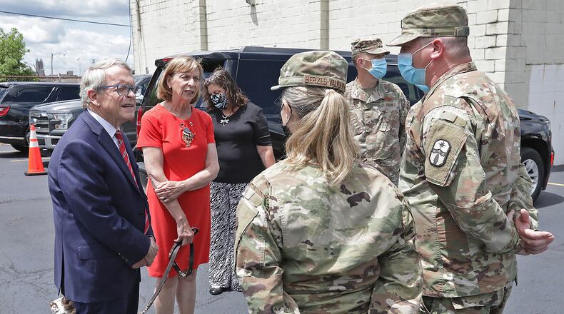 Governor Mike DeWine and his wife, Fran, stopped by the Second Harvest Food Bank to thank the members of the National Guard for helping distribute food during the pandemic. BILL LACKEY/STAFF
