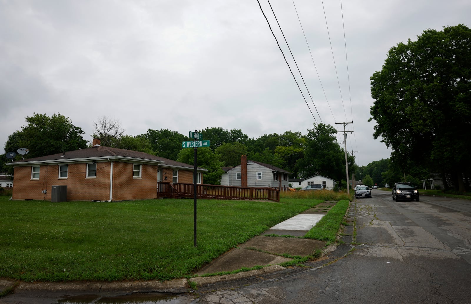 A vehicle drives on West Rose Street on Monday, June 30, 2025, in Springfield. A shooting happened on the 1000 block of West Rose Street on Saturday night that killed one person and injured four others. JOSEPH COOKE/STAFF