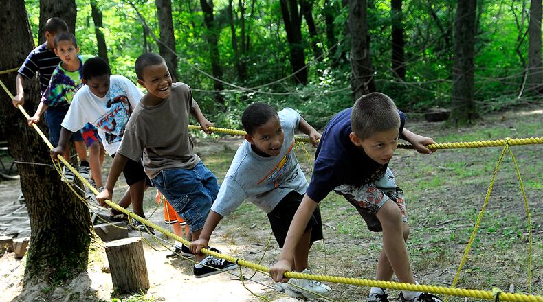 A group of Springfield children walk through an obstacle course at Camp Birch. Staff photo by Marshall Gorby