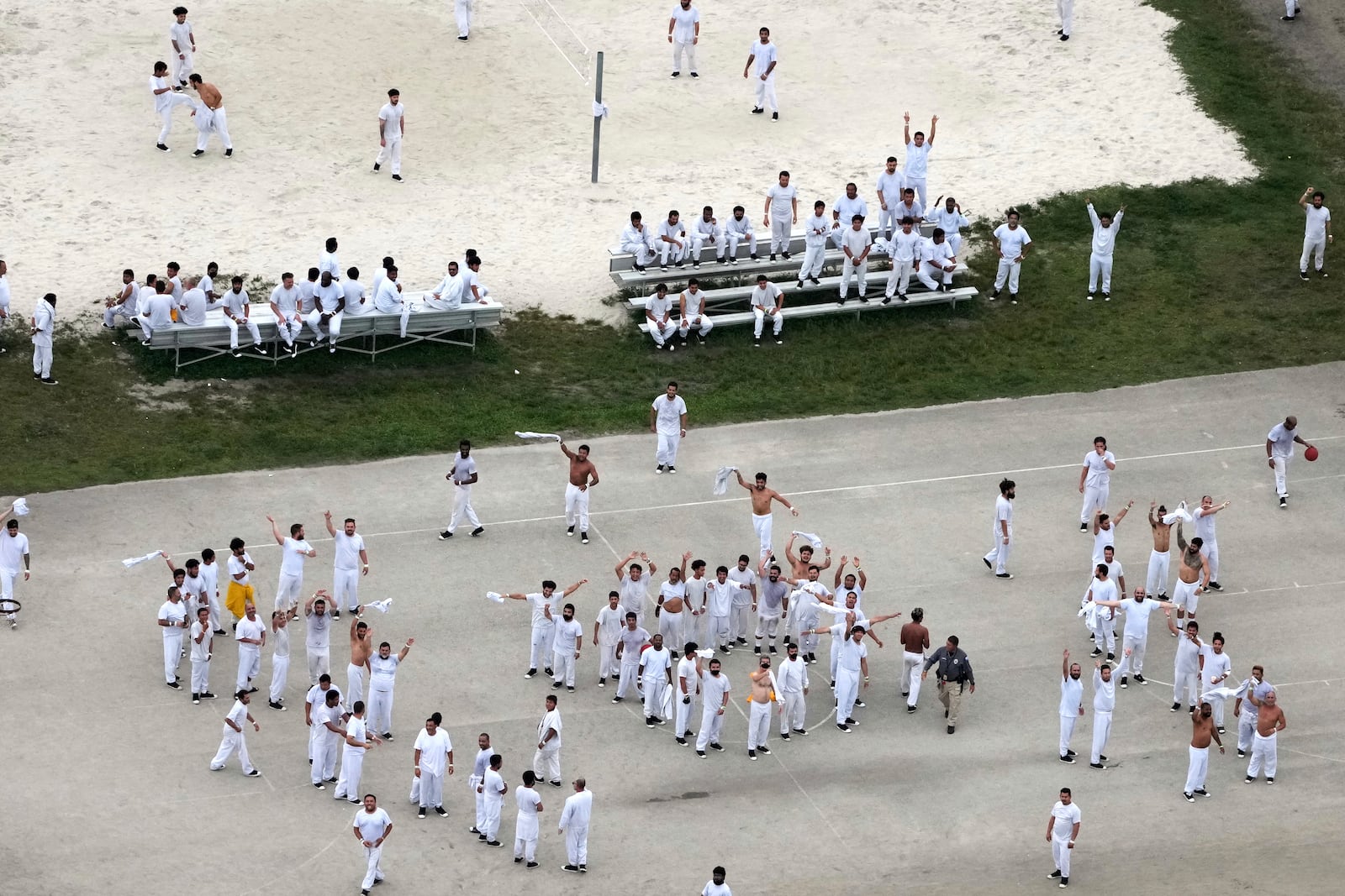 Detainees wave and spell out a rough SOS to a helicopter flying overhead, at U.S. Immigration and Customs Enforcement's Krome Detention Center, Thursday, July 3, 2025, in Miami. (AP Photo/Rebecca Blackwell)