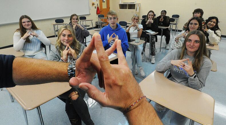 Springboro High School students in a college credit plus study group learn sign language. Springboro has the second-highest total college credit plus hours in the Miami Valley area. MARSHALL GORBY\STAFF