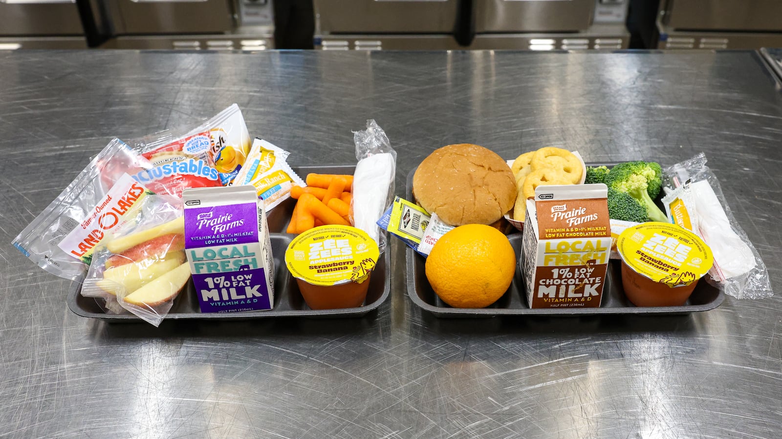 Typical lunches served to students by Fairborn City Schools. Milk, applesauce, vegetables and fruit are staples of each meal. BRYANT BILLING / STAFF