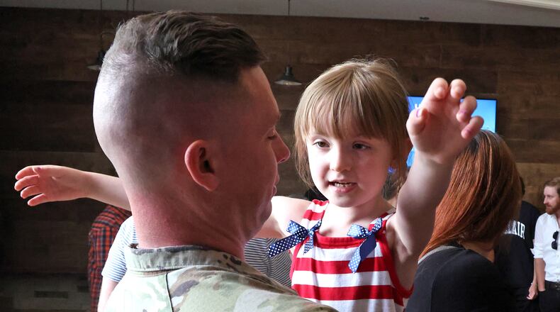 Calliope East gives her father, SSG Jacob East of the Ohio Army National Guard 1137th Tactical Installation Networking Enhanced Signal Company, a hug following a Call to Duty Ceremony for the unit Saturday, August 31, 2024 at the First Christian Church in Springfield. BILL LACKEY/STAFF