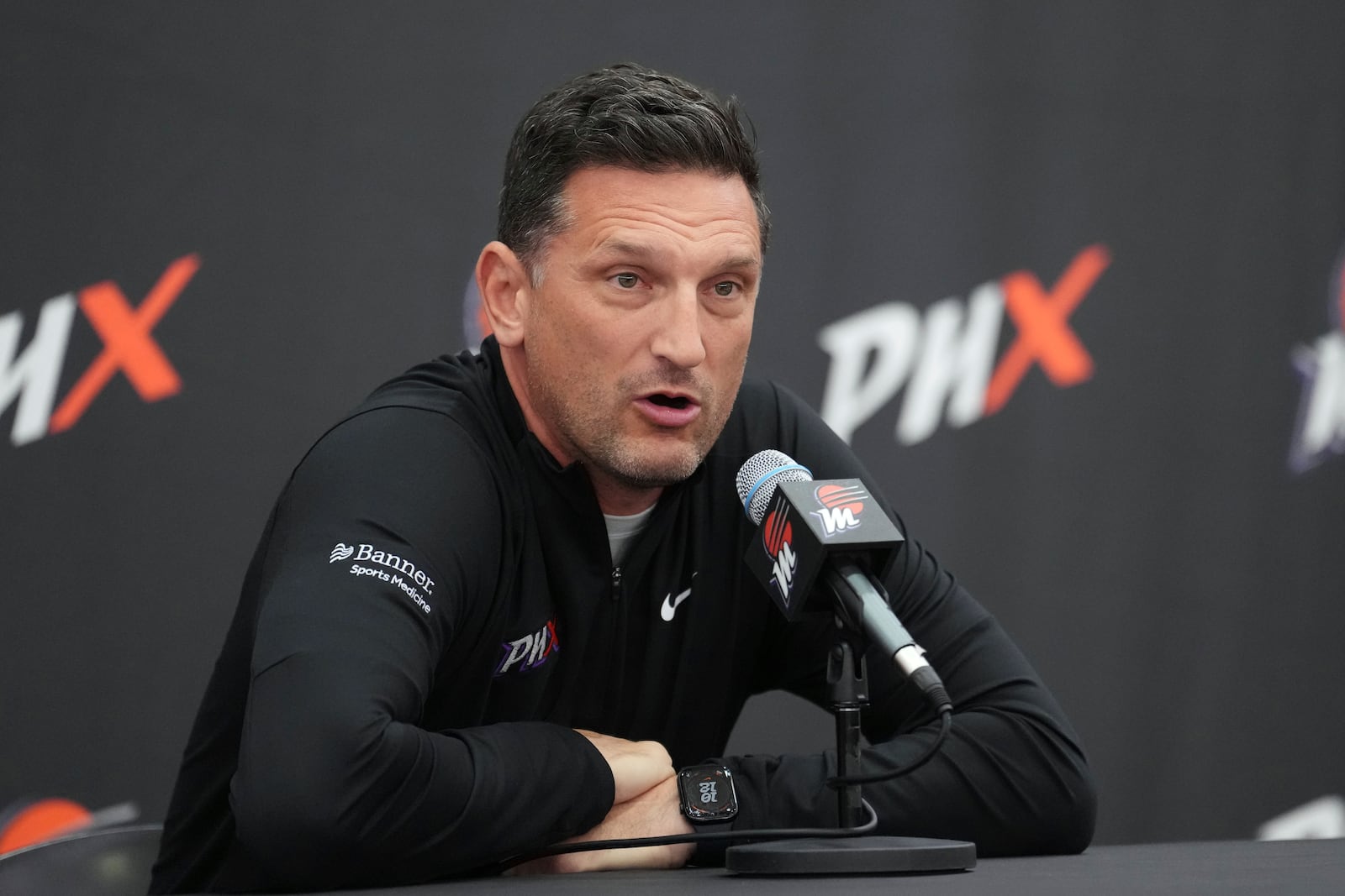 Phoenix Mercury head coach Nate Tibbetts answers a quesion from the media during Mercury Media Day at the team's WNBA basketball training facility, Wednesday, April 30, 2025, in Phoenix. (AP Photo/Ross D. Franklin)