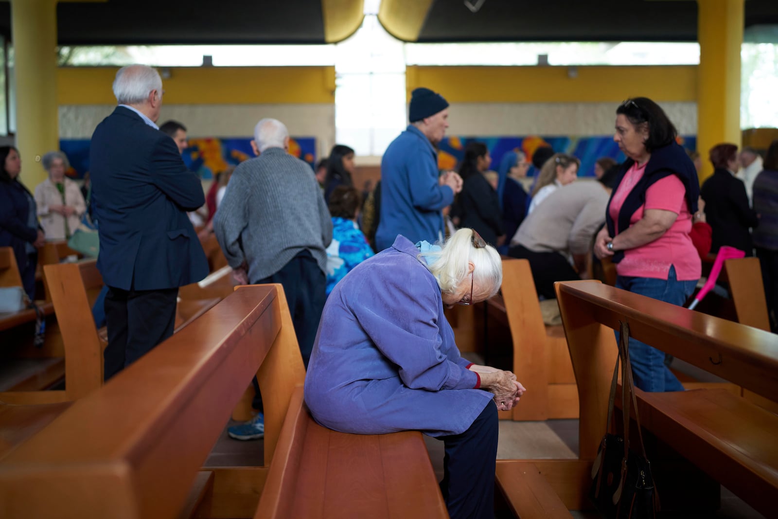 A woman prays during a mass in San Paolo Della Croce parish church in Corviale neighbourhood, in Rome, Sunday, May 4, 2025. (AP Photo/Alessandra Tarantino)