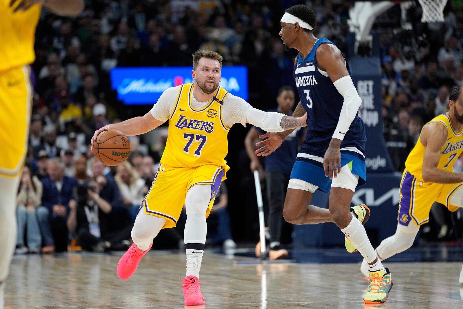 Los Angeles Lakers guard Luka Doncic (77) works toward the basket as Minnesota Timberwolves forward Jaden McDaniels (3) defends during the second half of Game 3 of an NBA basketball first-round playoff series, Friday, April 25, 2025, in Minneapolis. (AP Photo/Abbie Parr)