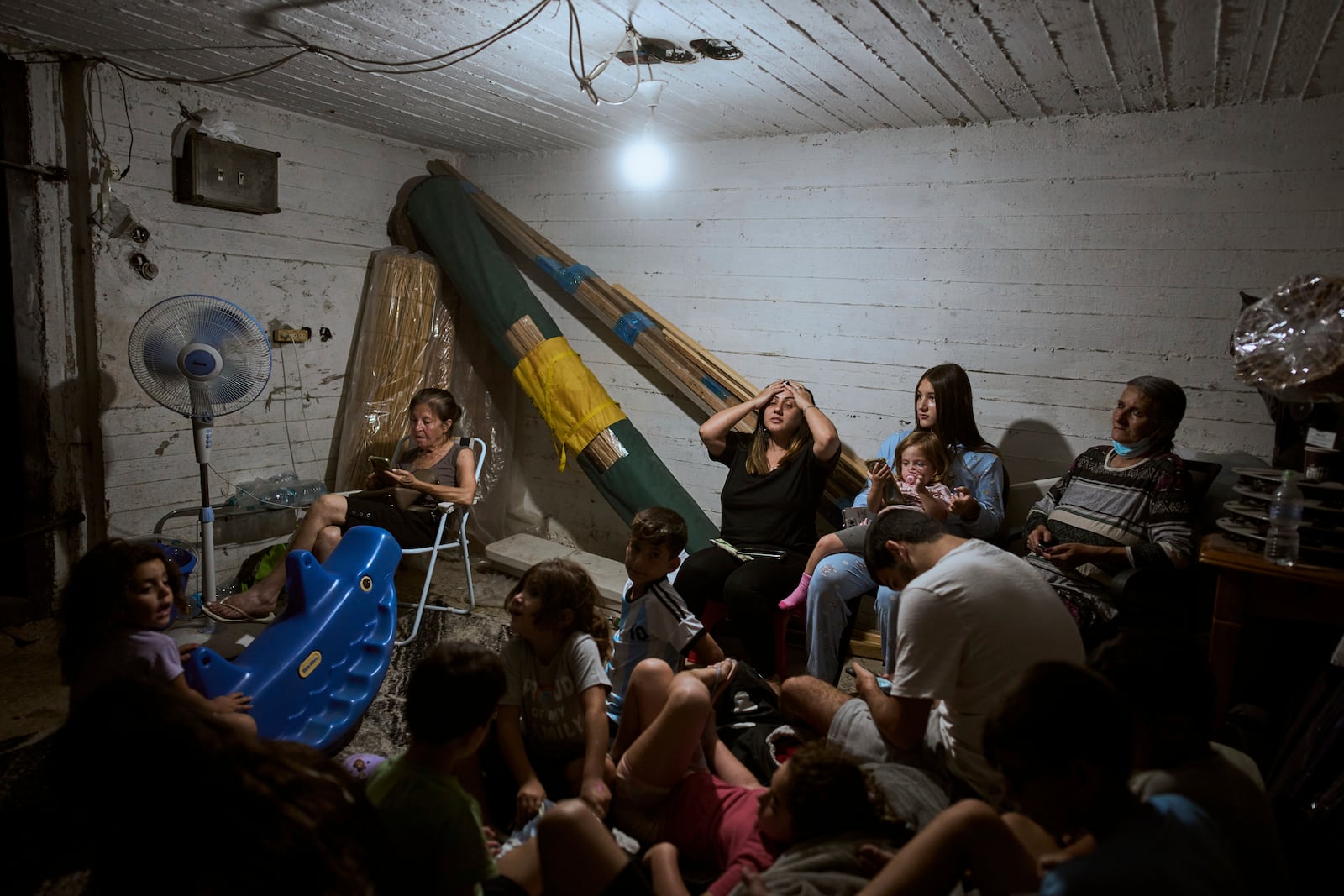 Israelis take shelter during air raid sirens warning of incoming strikes by Iran, in Bnei Brak, near Tel Aviv, Israel, Tuesday, June 17, 2025. (AP Photo/Oded Balilty)