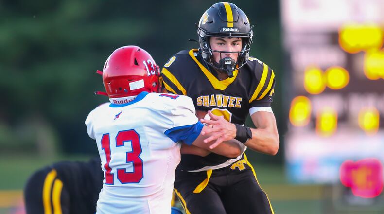 Shawnee High School junior R.J. Griffin runs through Northwestern junior Nathan Aldredge during the Braves 49-20 victory over the Warriors in Springfield. Griffin scored on the play. CONTRIBUTED PHOTO BY MICHAEL COOPER