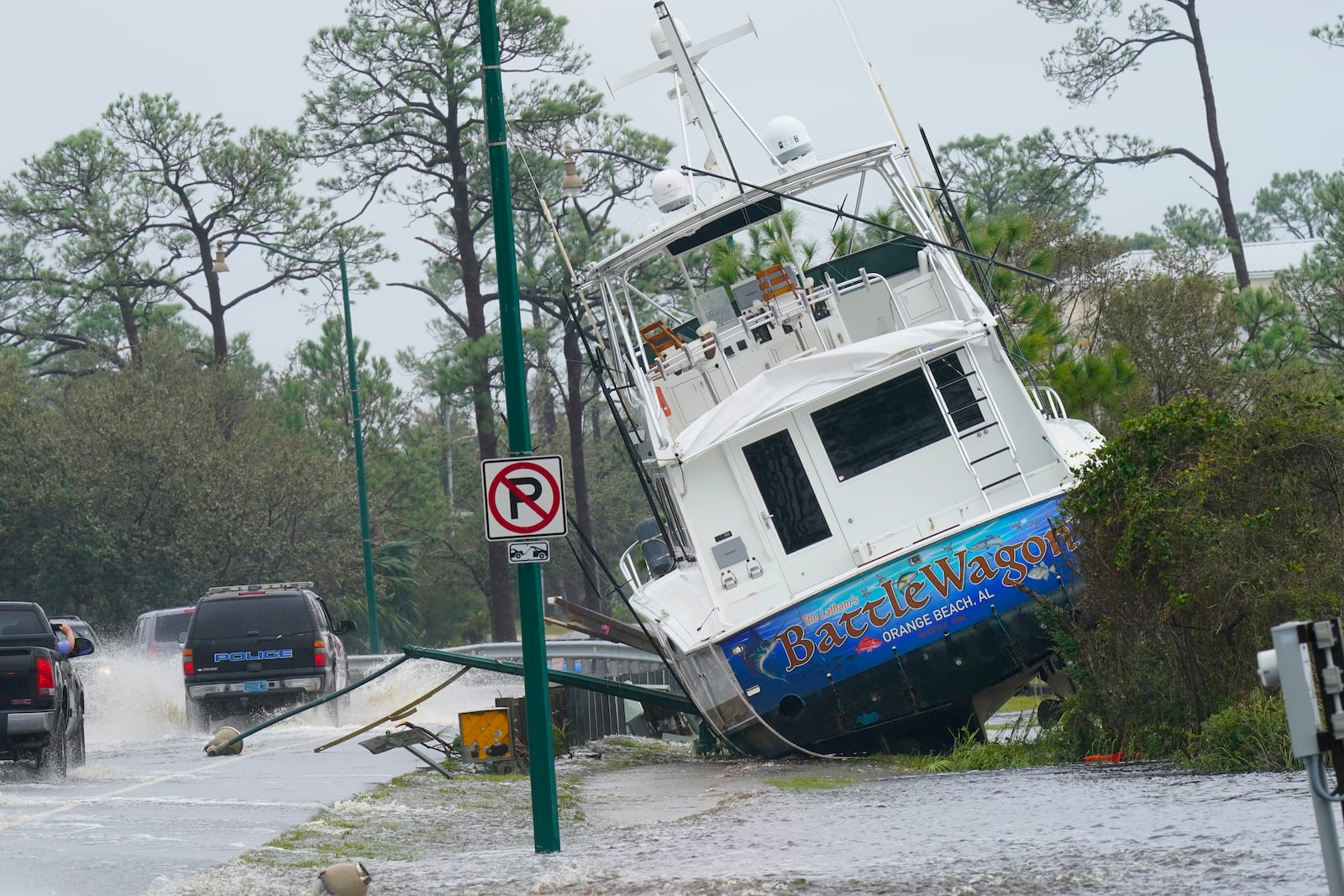 FILE - A boat is washed up near a road after Hurricane Sally moved through the area, Wednesday, Sept. 16, 2020, in Orange Beach, Ala. (AP Photo/Gerald Herbert, file)