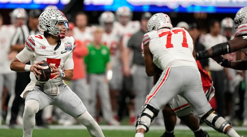 Ohio State quarterback C.J. Stroud (7) looks to pass in the pocket against Georgia during the first half of the Peach Bowl NCAA college football semifinal playoff game, Saturday, Dec. 31, 2022, in Atlanta. (AP Photo/Brynn Anderson)